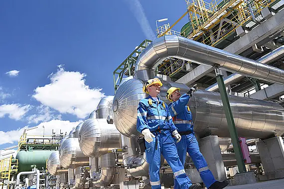 A group of industrial workers at a refinery